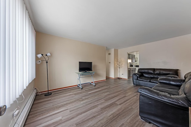 living room featuring hardwood / wood-style flooring and baseboard heating