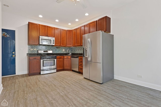 kitchen with ceiling fan, sink, decorative backsplash, and stainless steel appliances