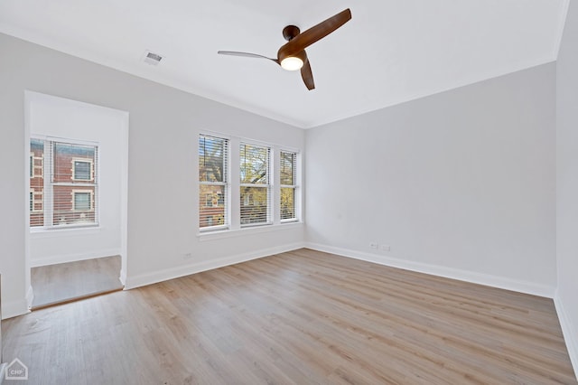 empty room with ceiling fan, crown molding, and light hardwood / wood-style floors