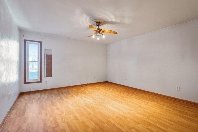 spare room with light hardwood / wood-style floors and ceiling fan