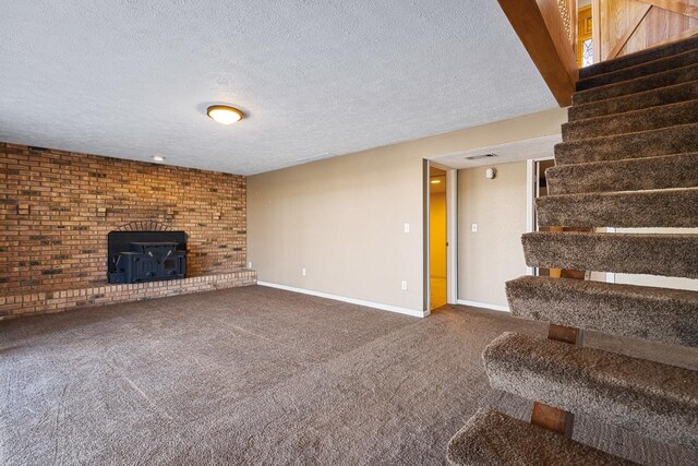 unfurnished living room with a wood stove, carpet, and a textured ceiling