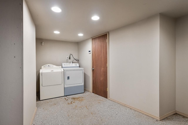 laundry room with washer and clothes dryer and light colored carpet