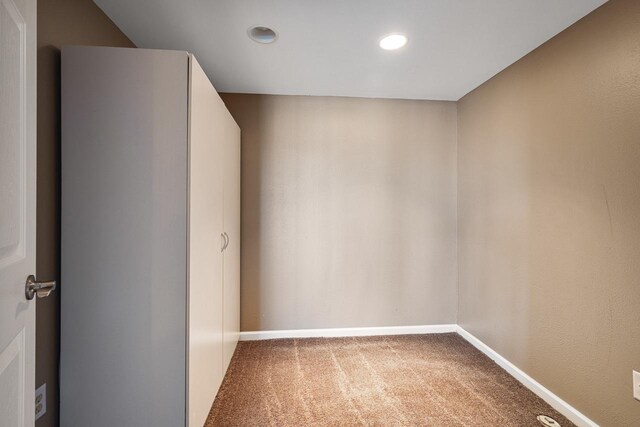 unfurnished room featuring carpet