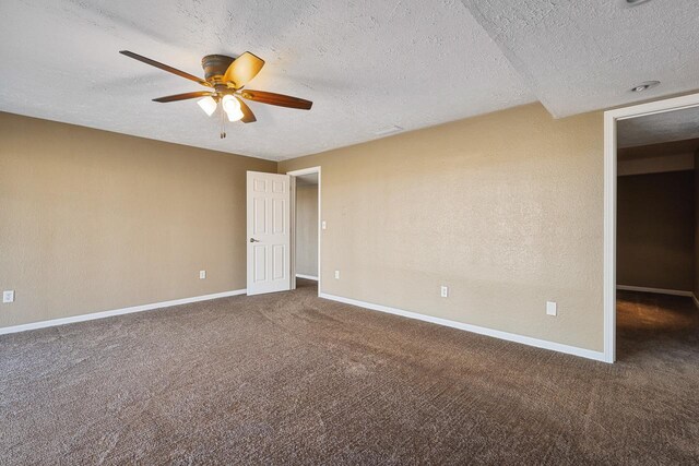 carpeted spare room with a textured ceiling and ceiling fan