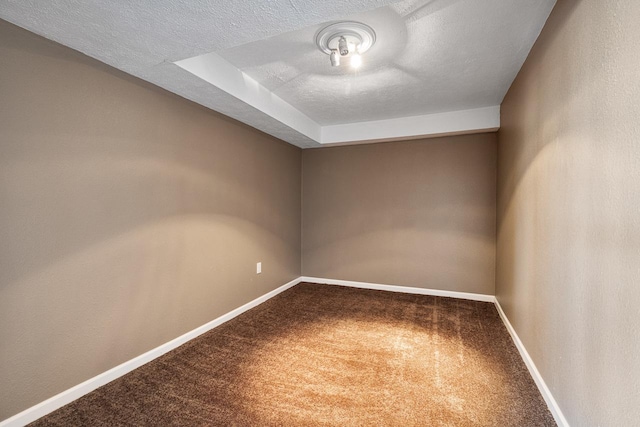 carpeted spare room featuring a textured ceiling