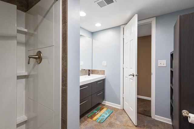 bathroom featuring vanity and a shower