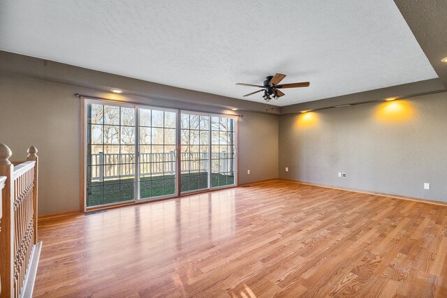 interior space featuring a textured ceiling, light hardwood / wood-style floors, and ceiling fan