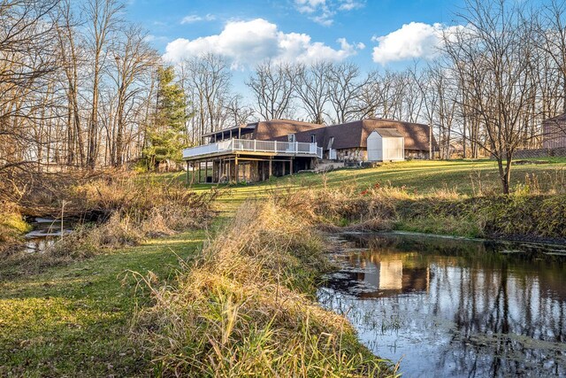 rear view of property with a deck with water view