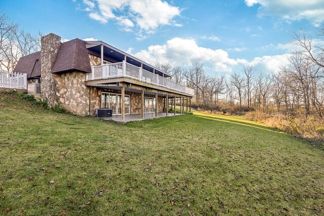 view of yard with a patio, central AC, and a wooden deck