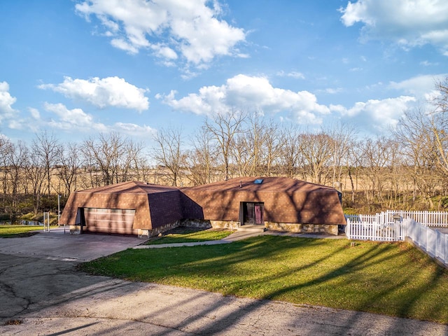 view of front of property with a garage and a front lawn