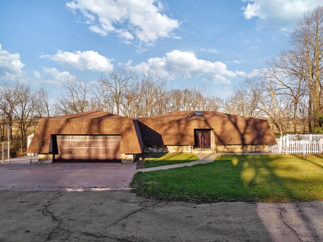 adobe home with a front yard and a garage