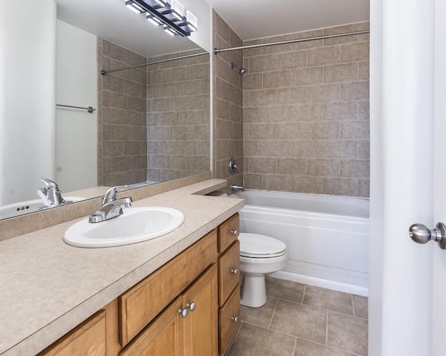 full bathroom featuring tile patterned flooring, vanity, tiled shower / bath combo, and toilet