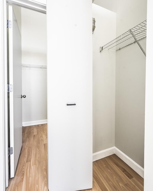 spacious closet featuring hardwood / wood-style flooring