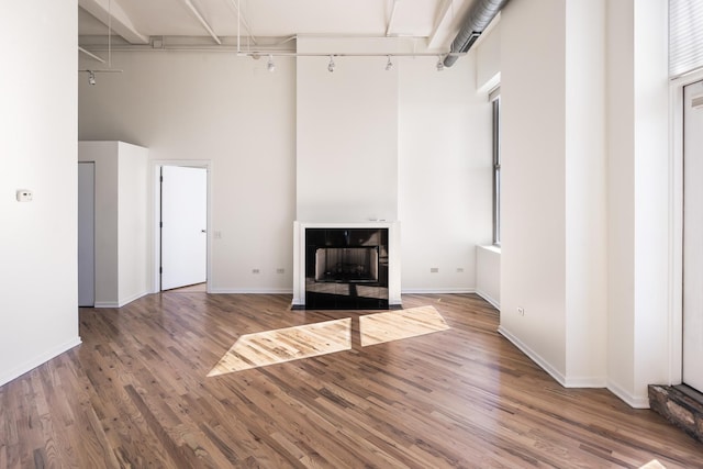 interior space featuring hardwood / wood-style floors and a towering ceiling