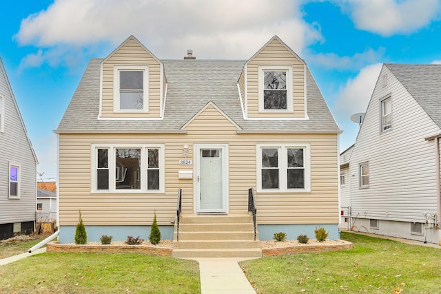 cape cod house with a front lawn