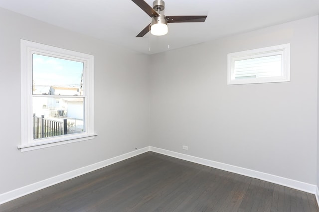 unfurnished room with ceiling fan, plenty of natural light, and dark wood-type flooring