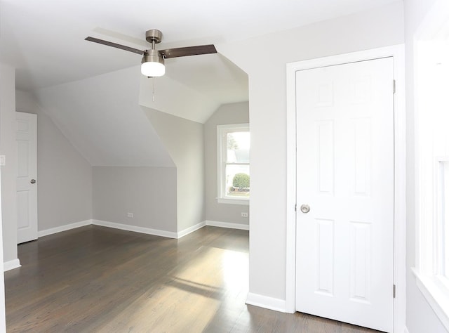 additional living space with ceiling fan, dark hardwood / wood-style floors, and vaulted ceiling