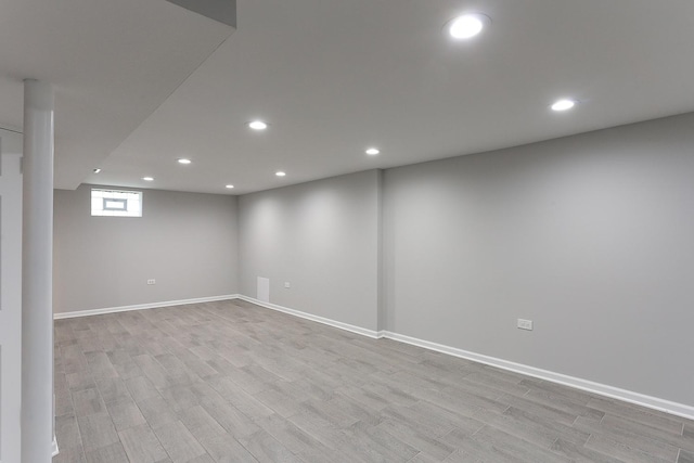 basement with light hardwood / wood-style floors