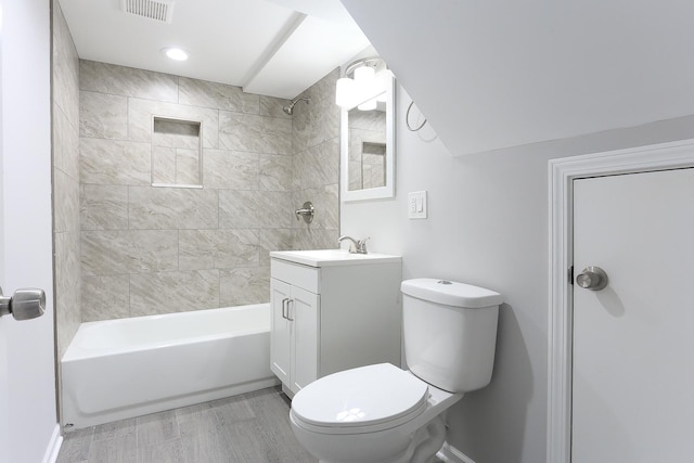 full bathroom with vanity, toilet, and tiled shower / bath