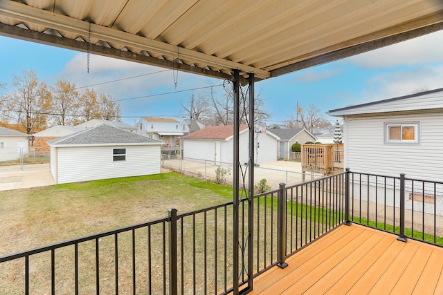 deck featuring a yard and an outdoor structure