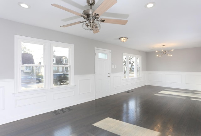 foyer entrance featuring ceiling fan with notable chandelier and dark hardwood / wood-style floors