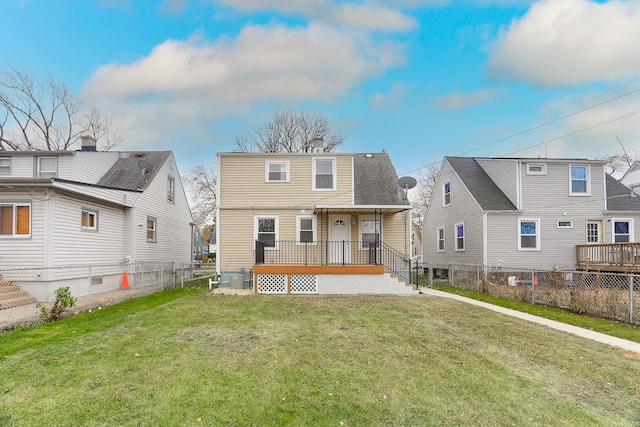 rear view of house with a yard