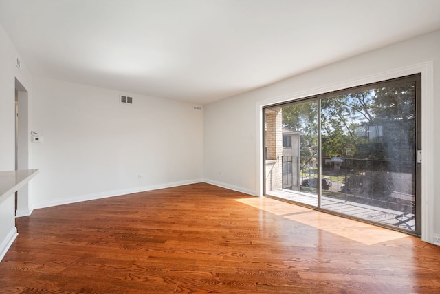 unfurnished room with wood-type flooring