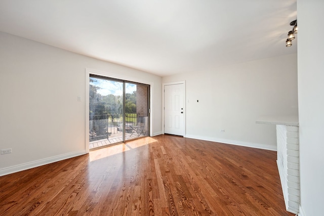 unfurnished living room featuring hardwood / wood-style floors and a fireplace