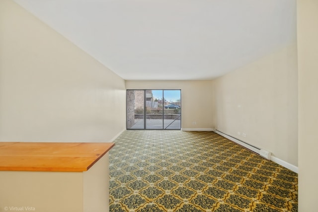 unfurnished living room featuring carpet and baseboard heating