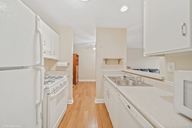 kitchen with white appliances, ceiling fan, sink, white cabinets, and light hardwood / wood-style floors