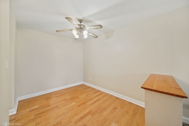 unfurnished room featuring ceiling fan and wood-type flooring