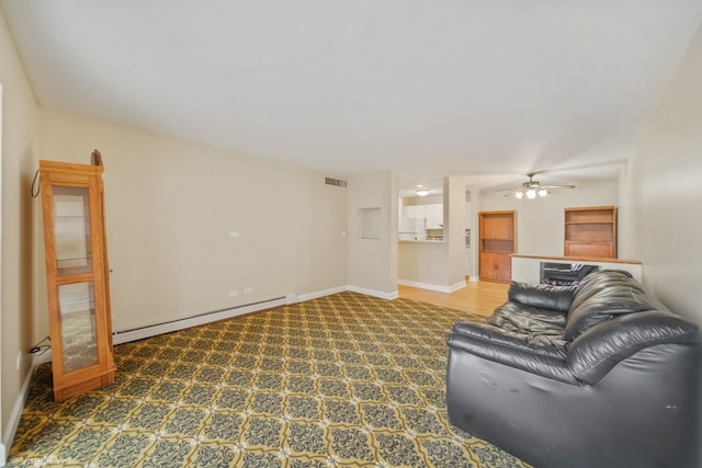 living room featuring baseboard heating and ceiling fan