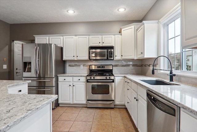 kitchen with white cabinetry, sink, and stainless steel appliances