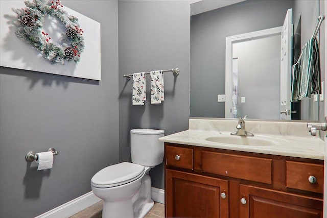 bathroom featuring tile patterned flooring, vanity, and toilet