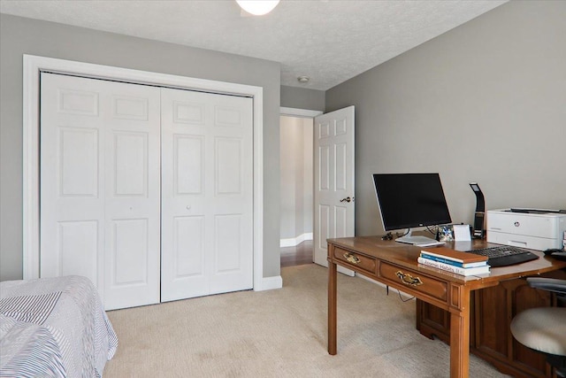 office with light carpet and a textured ceiling