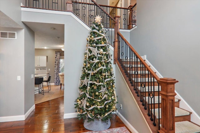 stairs featuring hardwood / wood-style floors and a textured ceiling