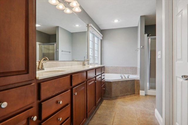 bathroom with tile patterned flooring, vanity, and separate shower and tub