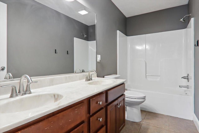 full bathroom featuring tile patterned flooring, vanity,  shower combination, and toilet