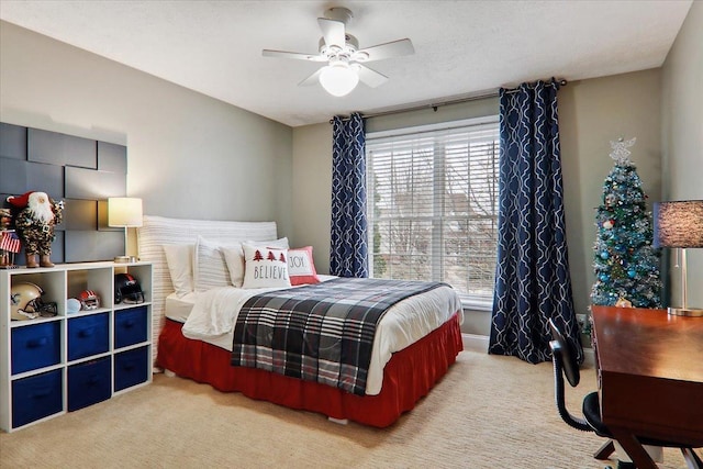 bedroom featuring light colored carpet and ceiling fan