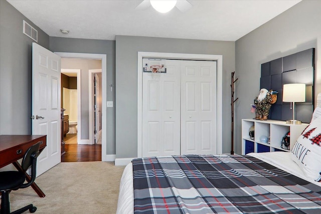 bedroom featuring ceiling fan, a closet, and carpet floors