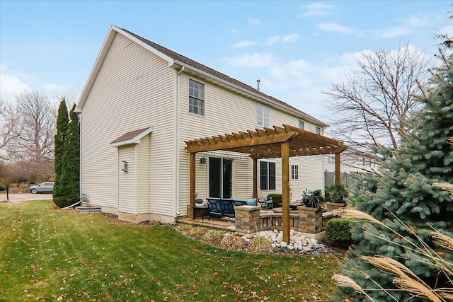 back of house featuring a yard and a pergola