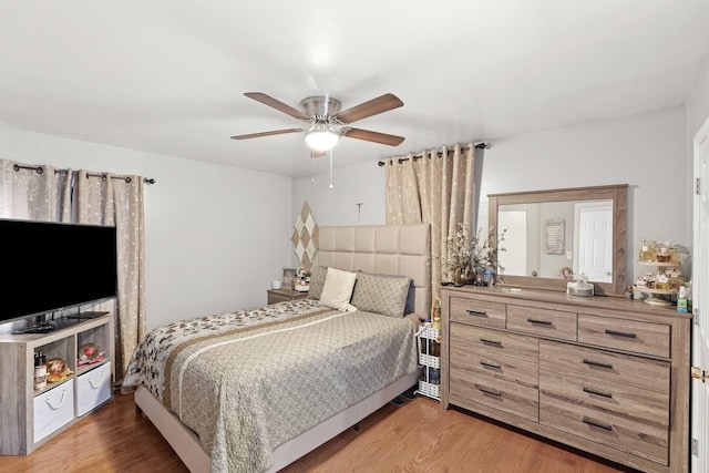 bedroom with hardwood / wood-style floors and ceiling fan