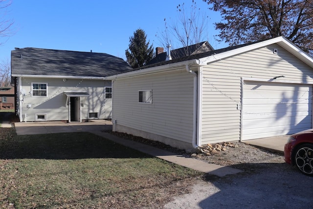 back of house featuring a garage