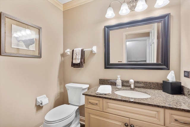 bathroom with toilet, ornamental molding, and vanity