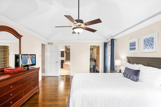 bedroom with ornamental molding, lofted ceiling, a walk in closet, and dark wood finished floors