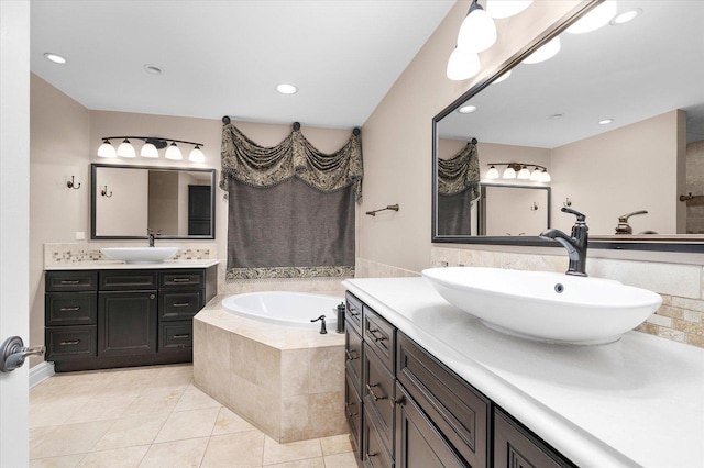 bathroom with two vanities, a sink, a bath, and tile patterned floors