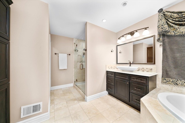 bathroom with a stall shower, visible vents, a garden tub, tile patterned flooring, and vanity