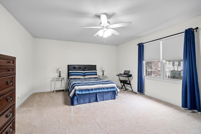 carpeted bedroom with ceiling fan and baseboards