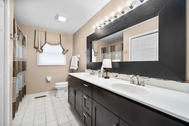 full bath with double vanity, tile patterned flooring, a sink, and toilet