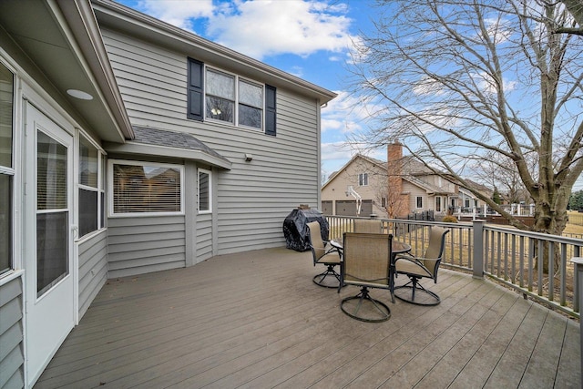 deck featuring outdoor dining area and a residential view